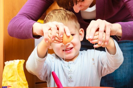 Little Boy Baking Cake With Mother, Breaking Egg.